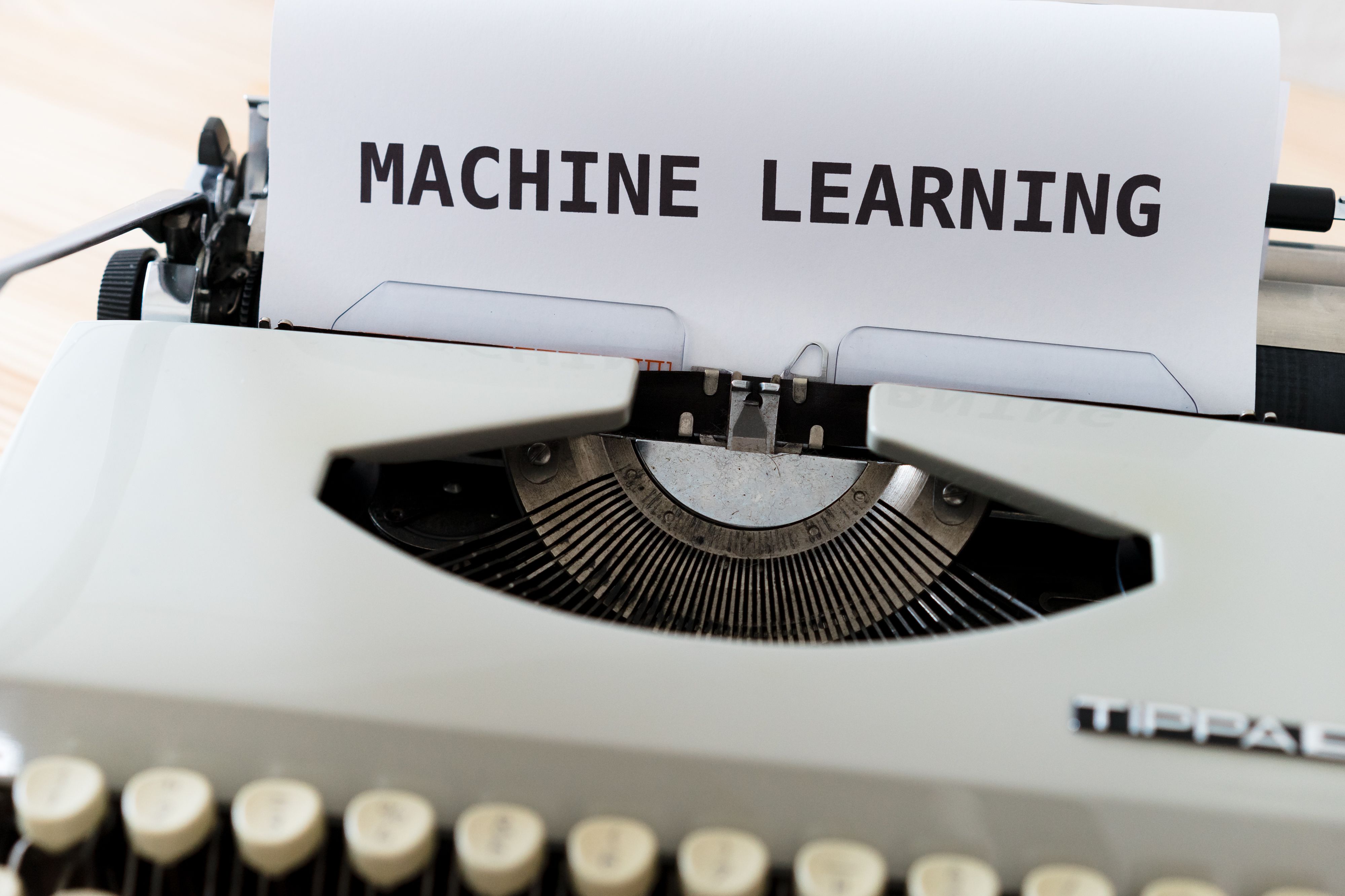 Vintage typewriter with paper reading Machine Learning, contrasting human and machine writing